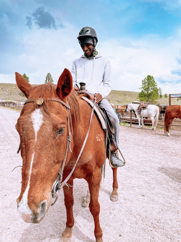 boy riding a horse wearing a helmet