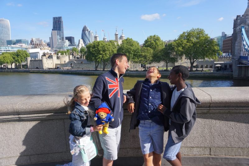 Laughing kids with Tower of London in Background | London with Kids | Global Munchkins