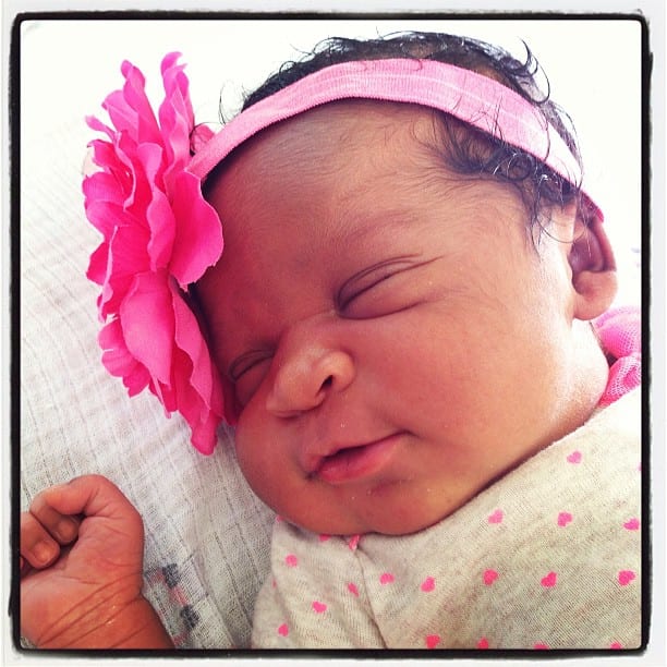 newborn bi-racial baby girl with pink bow